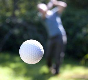 Golf instructor demonstrating the world class finish of the golf swing.