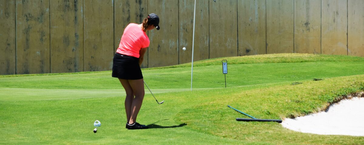 Armana Christianson hitting a one swing golf chip shot, because chipping is just a smaller version of your larger, full golf swing.